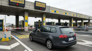 Auto al casello nella corsia Telepass con barriera abbassata e semaforo rosso, telepedaggio bloccato